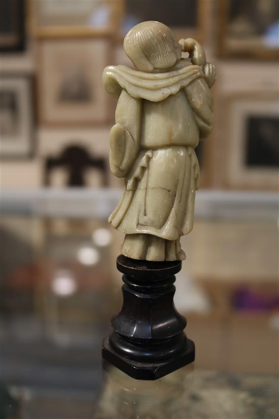 A Chinese soapstone carving of a man holding a jardiniere & other carvings